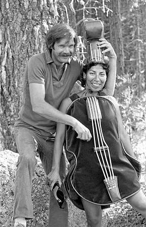 Michael Dixon plucking the strings of Christine de Herrera, Strawberry Bluegrass Festival, 1982, Leland Meadows
